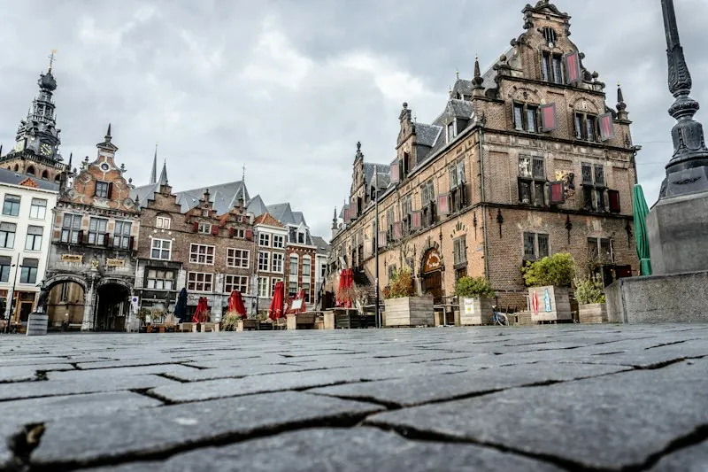 Mensen lopen langs een historisch stadhuis